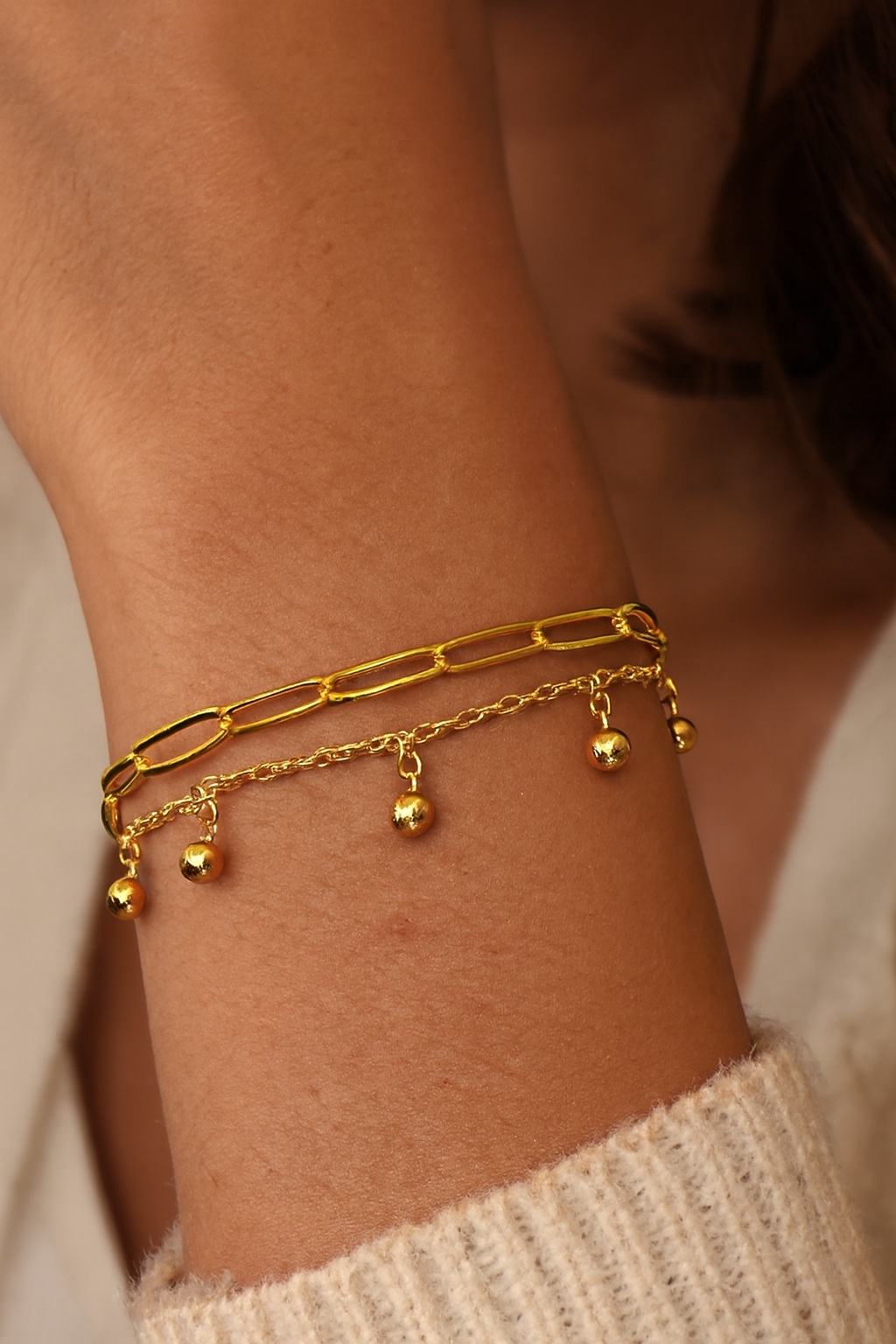 Femme portant un bracelet double chaîne avec petites perles pendantes dorées - Rêve de Rose