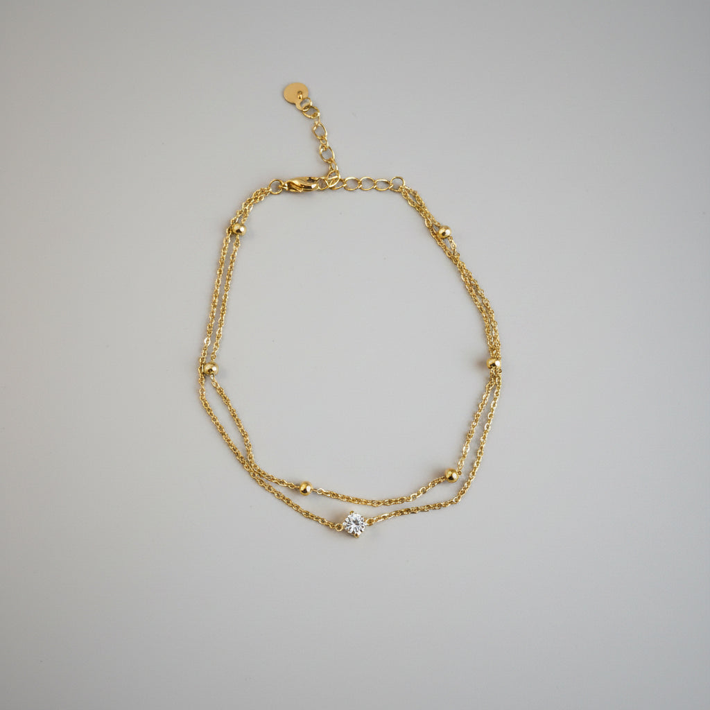 Chaîne de Cheville Double Chaîne Pierre Scintillante & Perles Dorées – Acier Inoxydable